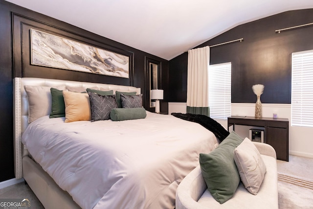 bedroom featuring lofted ceiling and carpet floors