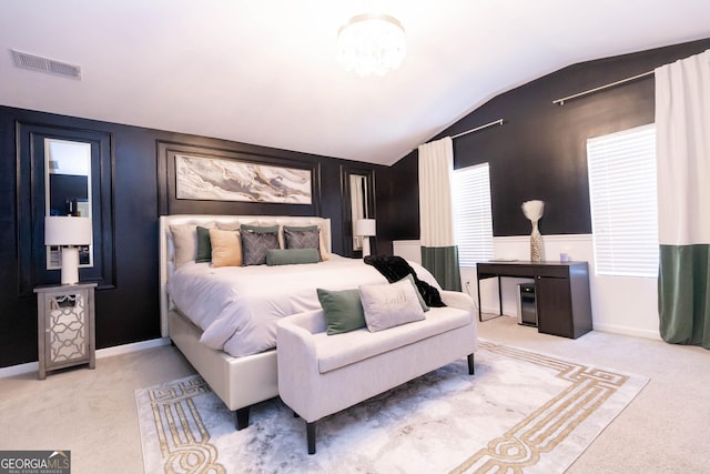 bedroom featuring visible vents, lofted ceiling, and carpet flooring