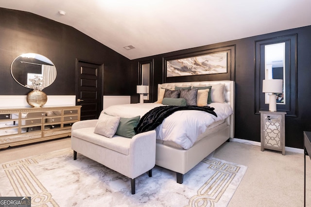 carpeted bedroom featuring visible vents, lofted ceiling, and baseboards