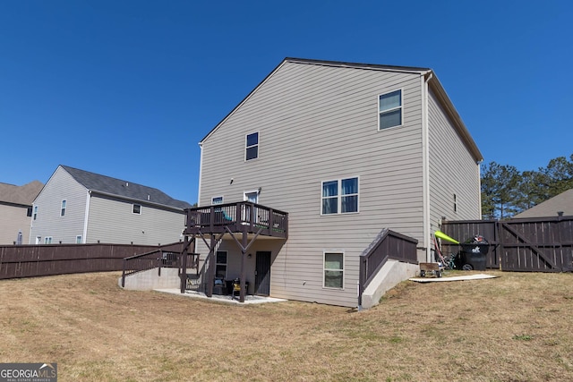 back of property featuring a deck, a yard, a patio area, and a fenced backyard