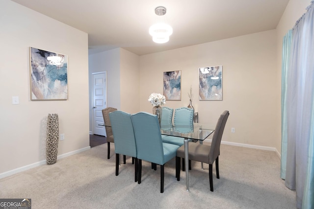 carpeted dining room with baseboards