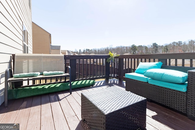 wooden terrace with an outdoor hangout area