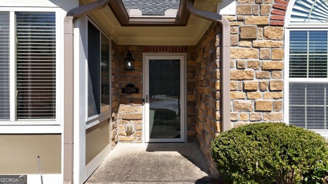 entrance to property with stone siding