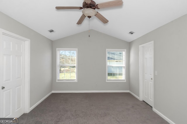 75 Heatherstone Way, Covington, GA 30016 - unfurnished bedroom with multiple windows, carpet flooring, vaulted ceiling, and a ceiling fan
