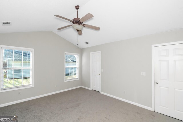 75 Heatherstone Way, Covington, GA 30016 - unfurnished bedroom with light carpet, lofted ceiling, and a ceiling fan