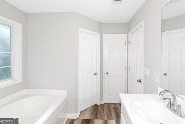 75 Heatherstone Way, Covington, GA 30016 - full bath with wood finished floors, a bath, and vanity