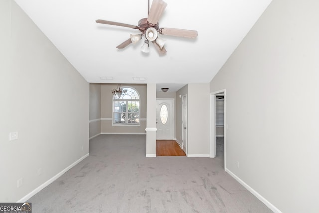 75 Heatherstone Way, Covington, GA 30016 - unfurnished living room with carpet floors, a chandelier, and ceiling fan