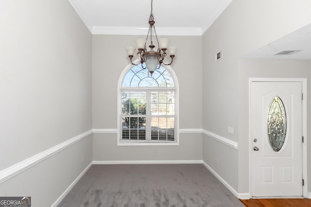 75 Heatherstone Way, Covington, GA 30016 - foyer entrance featuring a chandelier, crown molding, and carpet