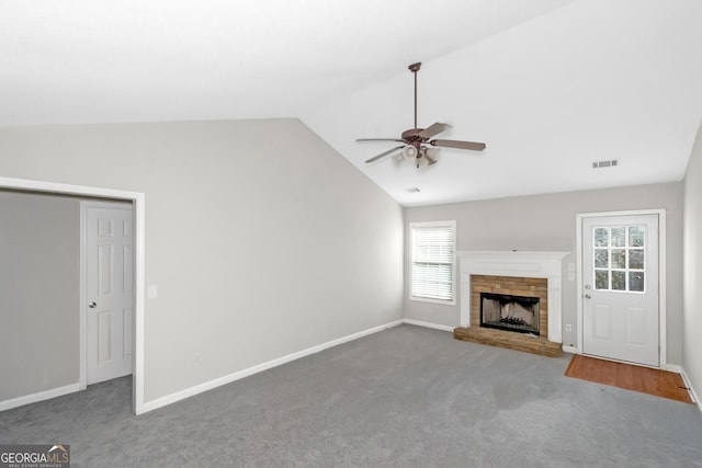 75 Heatherstone Way, Covington, GA 30016 - unfurnished living room featuring ceiling fan, vaulted ceiling, carpet flooring, and a brick fireplace