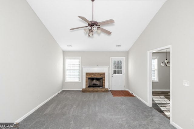 75 Heatherstone Way, Covington, GA 30016 - unfurnished living room featuring ceiling fan, carpet flooring, a chandelier, a fireplace, and vaulted ceiling
