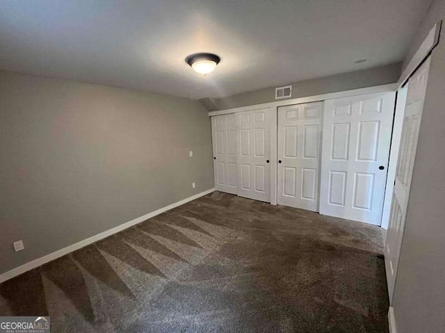 unfurnished bedroom featuring visible vents, baseboards, and carpet