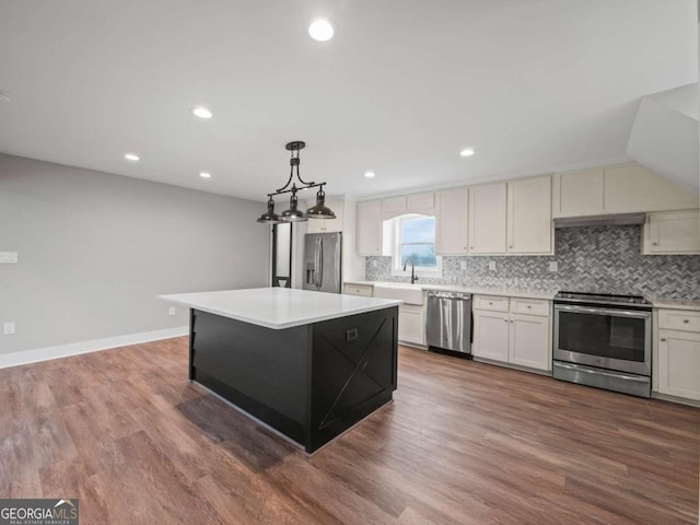 kitchen featuring tasteful backsplash, stainless steel appliances, light countertops, and dark wood-type flooring