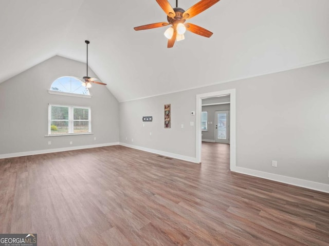 unfurnished living room featuring baseboards, high vaulted ceiling, wood finished floors, and a ceiling fan