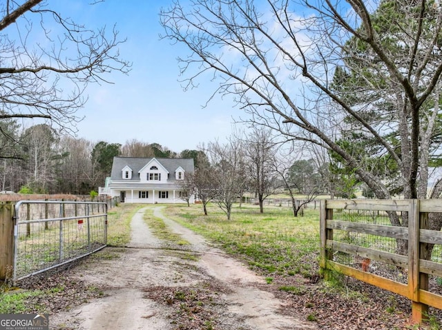 view of road featuring a gated entry, driveway, and a gate