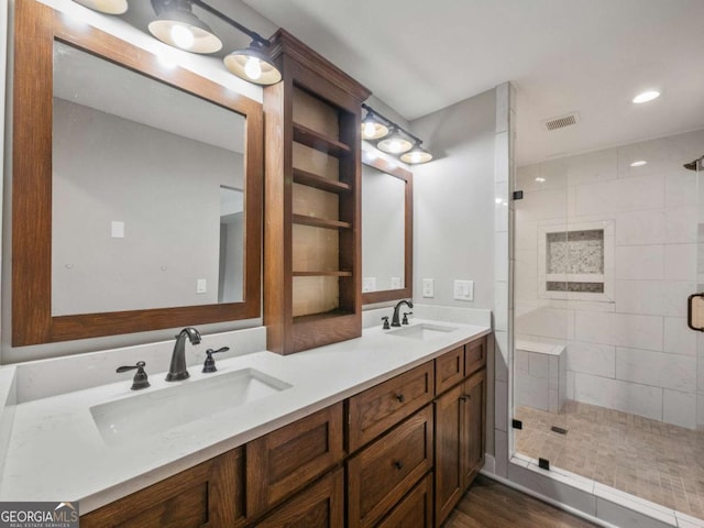 full bathroom with a stall shower, visible vents, and a sink