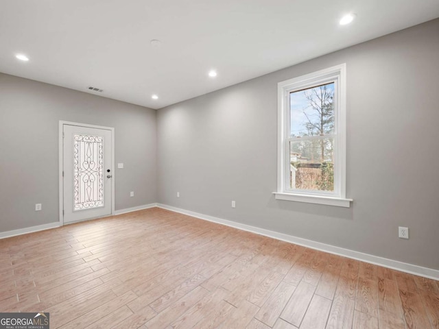 spare room featuring recessed lighting, visible vents, baseboards, and light wood-style flooring