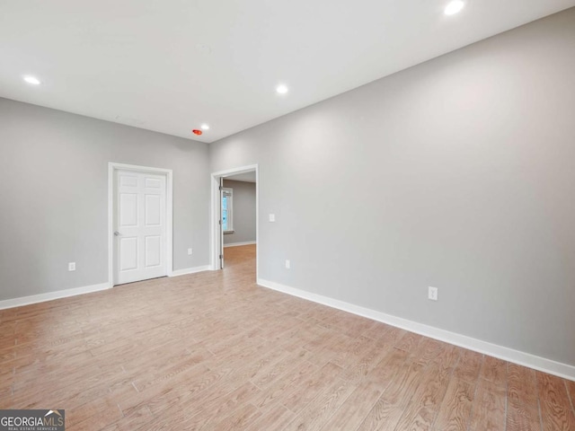 empty room with recessed lighting, baseboards, and light wood-style flooring