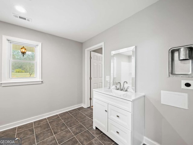 bathroom featuring tile patterned flooring, visible vents, vanity, and baseboards