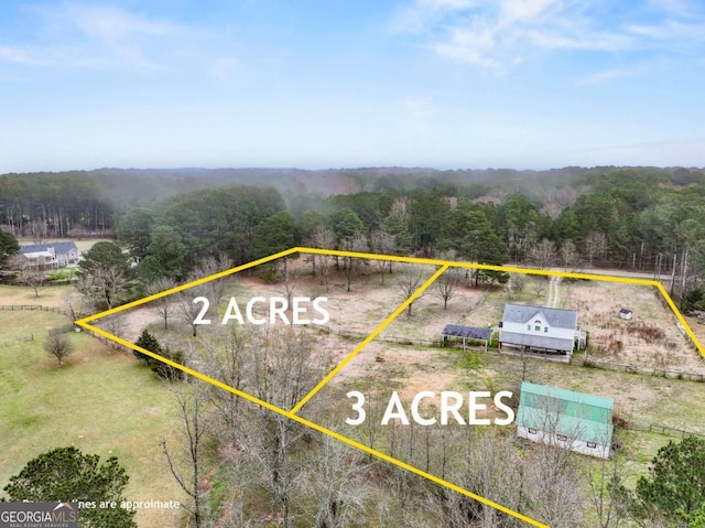 drone / aerial view with a rural view and a wooded view