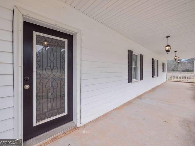 view of exterior entry featuring a porch