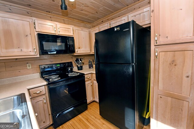 kitchen with black appliances, wood ceiling, light countertops, and light brown cabinetry