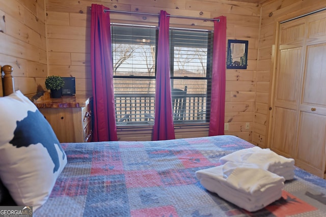 bedroom with a closet and wooden walls