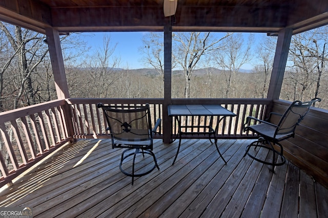 wooden deck with a view of trees