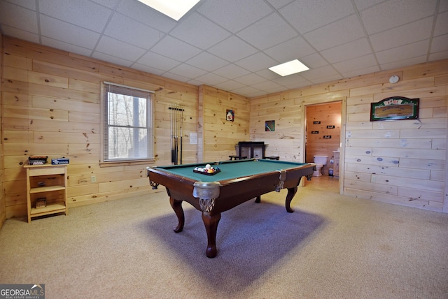 recreation room featuring light carpet, wooden walls, pool table, and a paneled ceiling