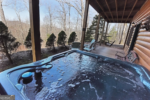 view of swimming pool featuring a hot tub