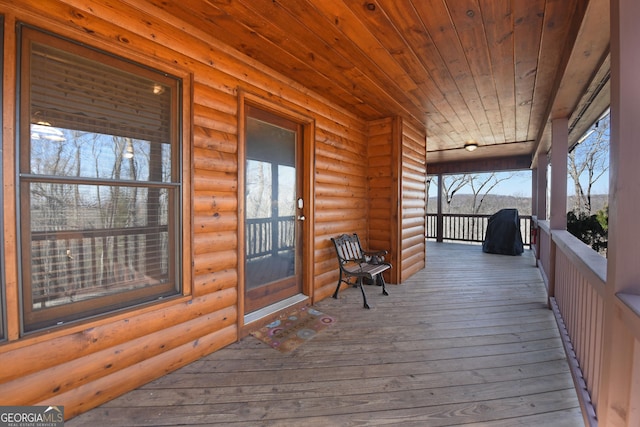 wooden terrace featuring covered porch