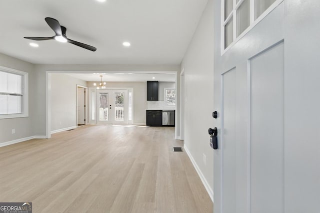 unfurnished living room featuring recessed lighting, light wood-style floors, visible vents, and baseboards