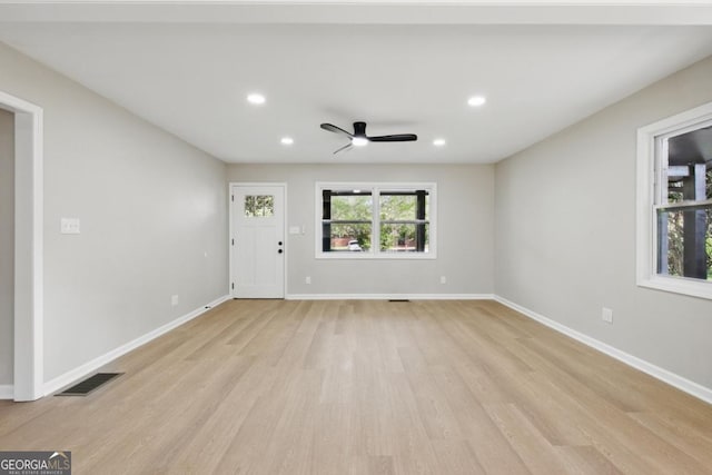 unfurnished living room with visible vents, a ceiling fan, recessed lighting, light wood-style floors, and baseboards