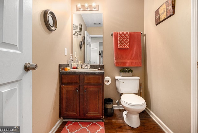 1921 Boulder Gate Dr, Ellenwood, GA 30294 - bathroom featuring visible vents, toilet, wood finished floors, baseboards, and vanity