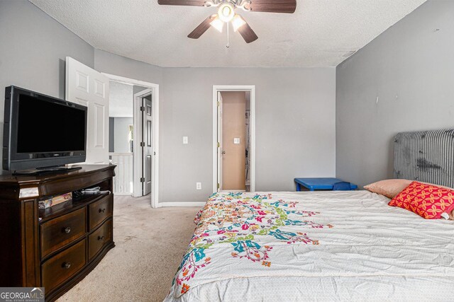 1921 Boulder Gate Dr, Ellenwood, GA 30294 - bedroom featuring light colored carpet, a textured ceiling, baseboards, and ceiling fan