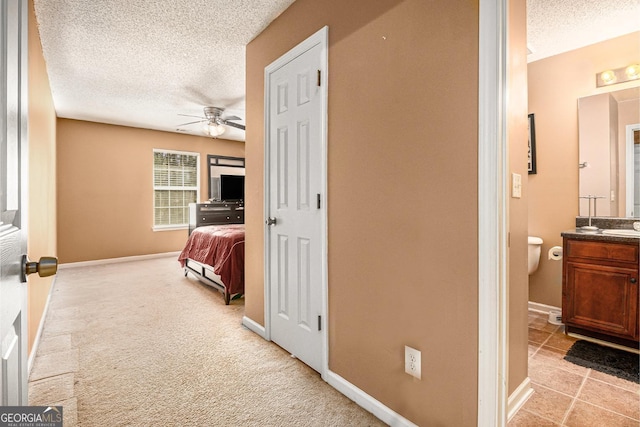 1921 Boulder Gate Dr, Ellenwood, GA 30294 - hallway featuring light colored carpet, baseboards, and a textured ceiling