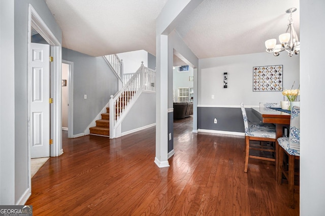 1921 Boulder Gate Dr, Ellenwood, GA 30294 - dining room featuring baseboards, a chandelier, stairs, wood finished floors, and a textured ceiling