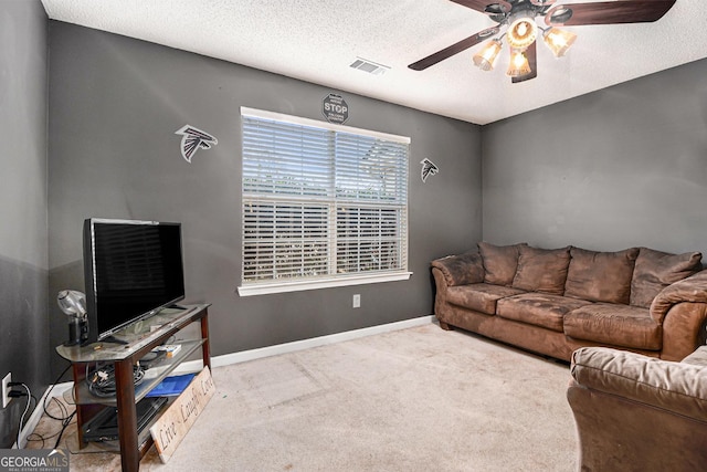 1921 Boulder Gate Dr, Ellenwood, GA 30294 - living area with visible vents, baseboards, ceiling fan, carpet floors, and a textured ceiling