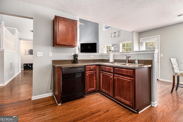 1921 Boulder Gate Dr, Ellenwood, GA 30294 - kitchen featuring dark countertops, visible vents, dishwasher, a peninsula, and a sink