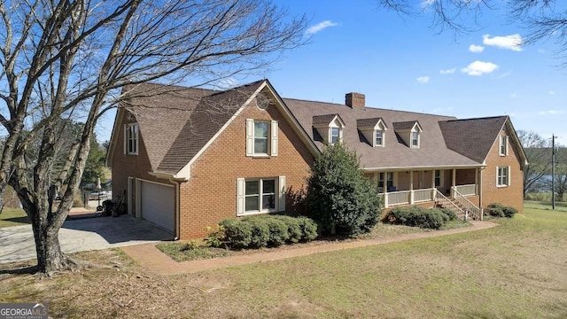 view of front of property with brick siding, a porch, concrete driveway, a front yard, and a chimney