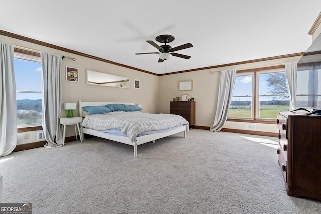 carpeted bedroom with visible vents, ceiling fan, crown molding, and baseboards