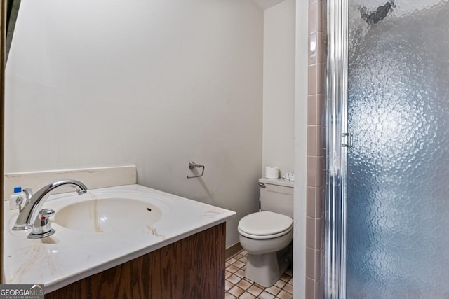 full bath with tile patterned floors, a stall shower, toilet, and vanity