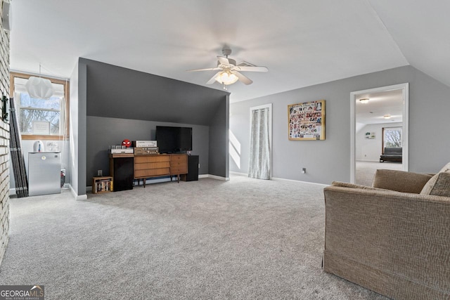 living area featuring baseboards, carpet floors, lofted ceiling, and a ceiling fan