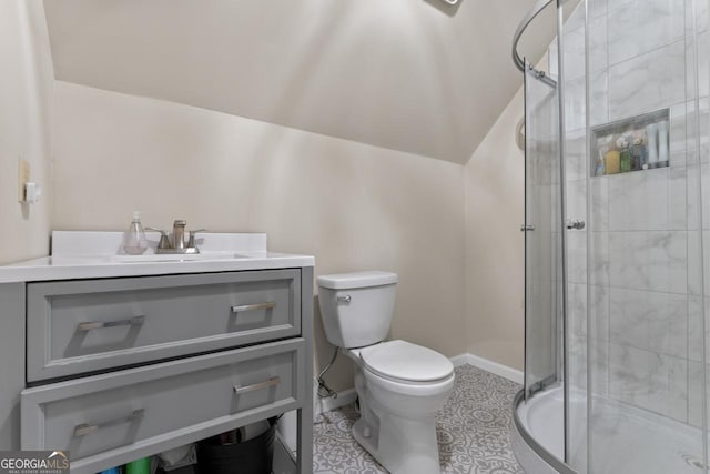 bathroom featuring vanity, baseboards, a stall shower, vaulted ceiling, and toilet