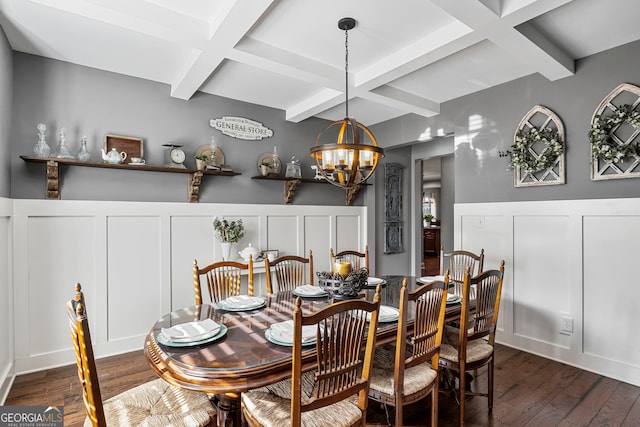 dining space with a chandelier, beamed ceiling, dark wood-style floors, and a decorative wall