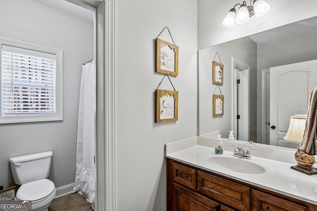 full bathroom with tile patterned flooring, toilet, vanity, and baseboards