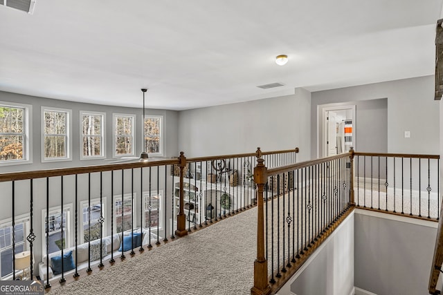 hallway featuring visible vents and carpet