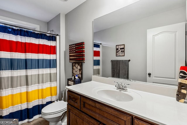 bathroom featuring vanity, toilet, and a shower with curtain