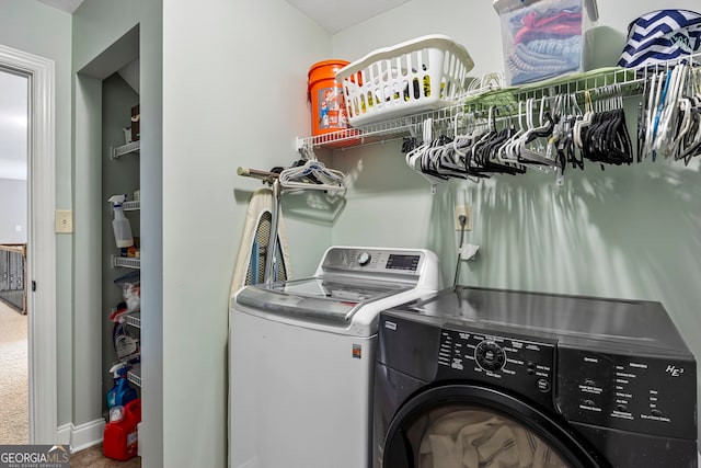 washroom with carpet flooring, washing machine and dryer, and laundry area