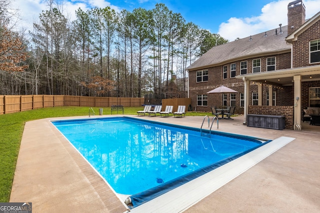 view of swimming pool with a fenced in pool, a yard, a fenced backyard, and a patio area