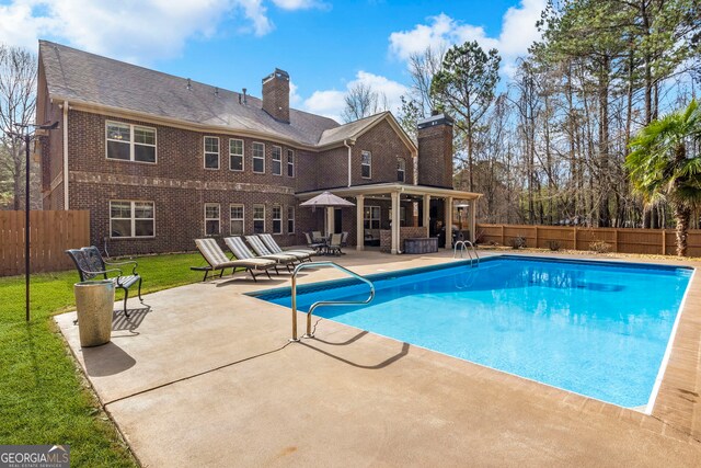 view of pool featuring a fenced in pool, a patio, a lawn, and a fenced backyard